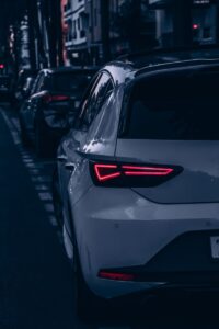 Rearview of cars on a city street in Rabat at night, highlighting urban transportation.